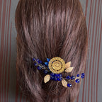 Makr Gold and Blue one coin comb hair accessories displaying intricate design on brown hair.